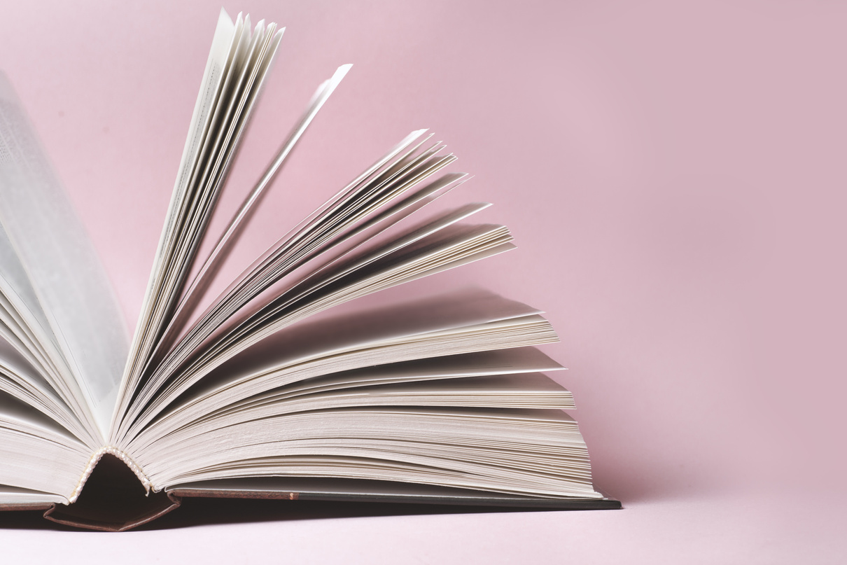 Stack of colorful books, grungy blue background,